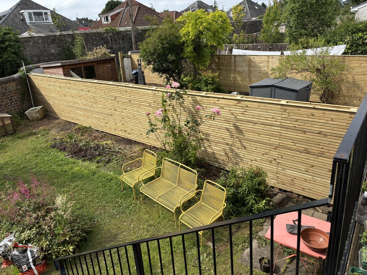 Horizontal slatted timber fence on a sloped Glasgow garden