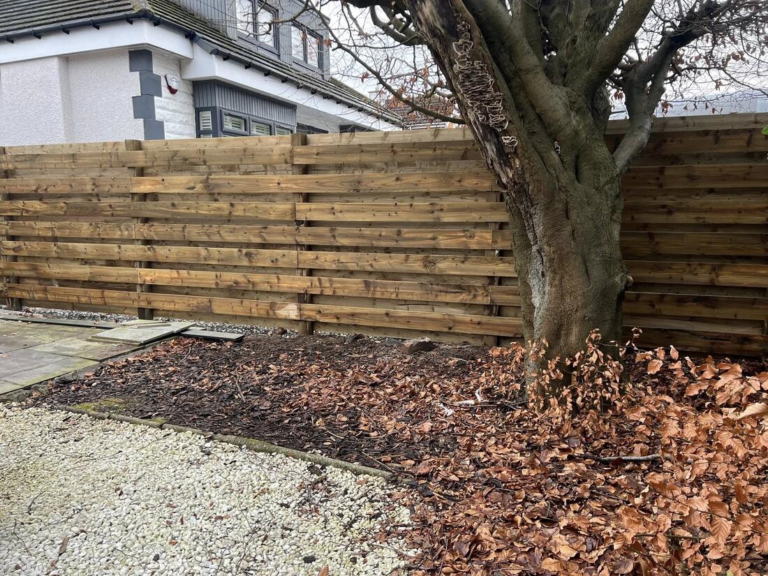 Slatted fence with bark beds